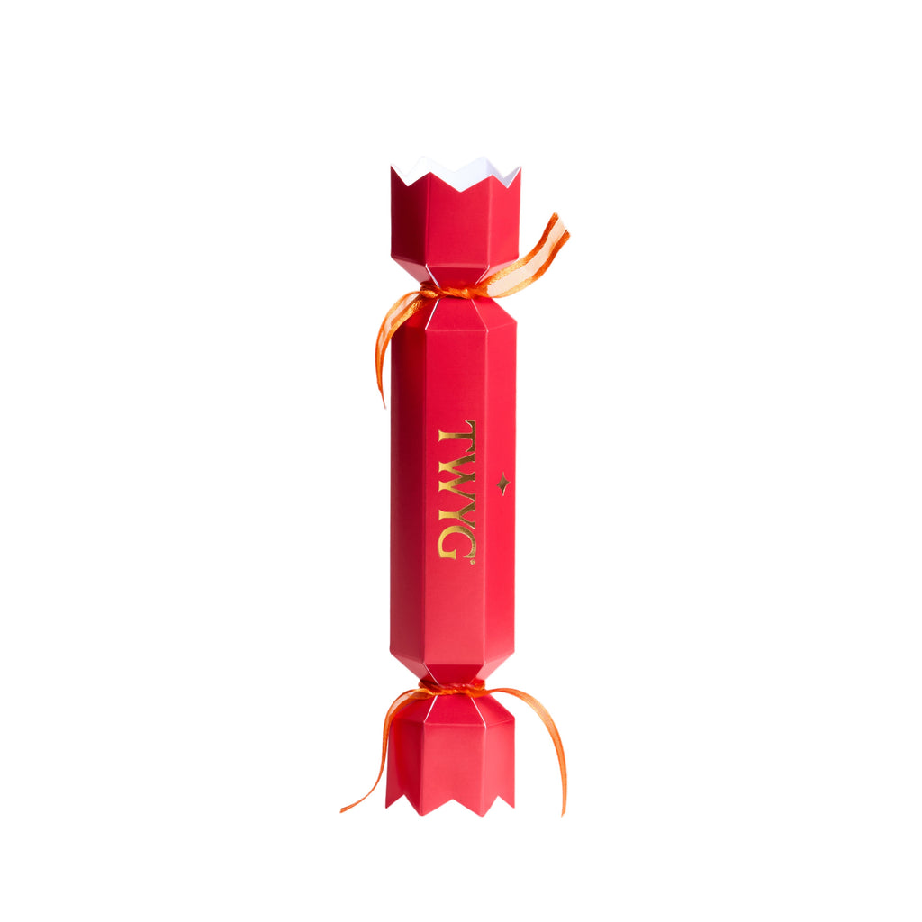 TWYG red holiday gift cracker with gold logo and orange ribbon, luxury festive beauty gift packaging