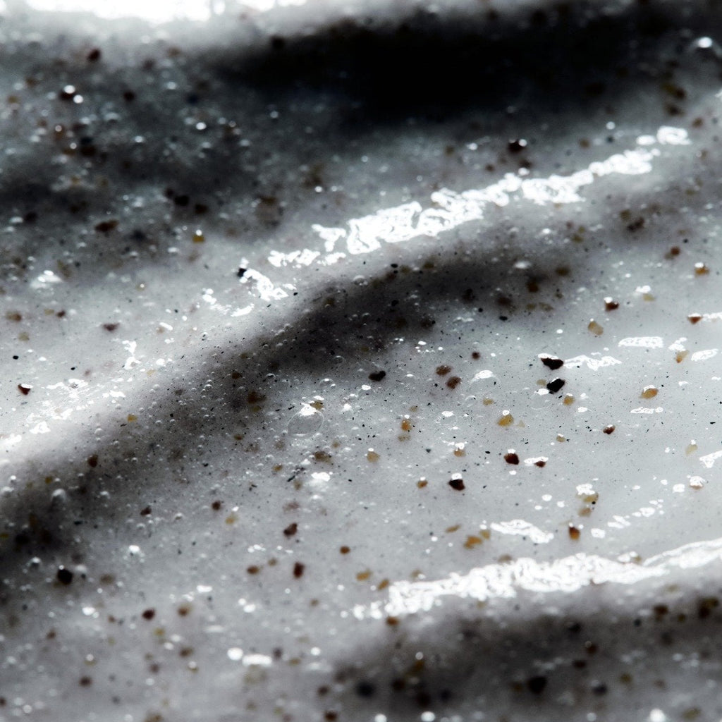 Close-up of LESSE Refining Cleanser texture with micro-exfoliating botanicals and charcoal to deeply cleanse and detoxify - Gllosse