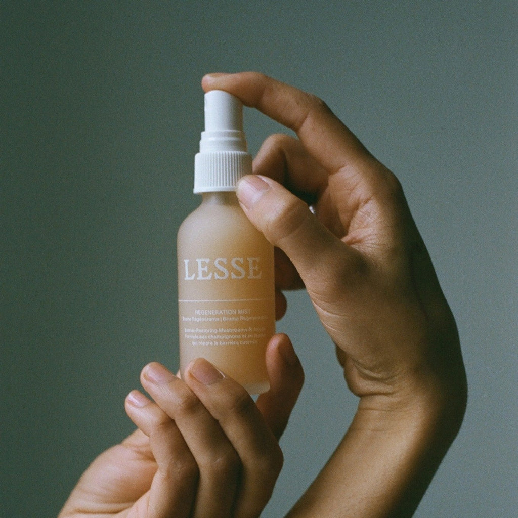 Lesse Regeneration Mist Barrier-Restoring Mushrooms & Jojoba Model holding bottle - Gllosse
